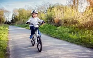 Young boy biking on a trail.