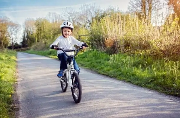 Young boy biking on a trail.