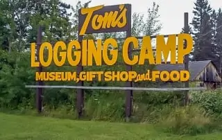 Tom's Logging Camp sign. Text: Museum, Gift Shop and Food.