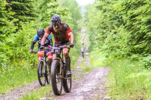Every year, on the last Saturday of June, Lutsen plays host to a series of mountain bike races that take riders through the vast wilderness of Northern Minnesota. Cutting through dirt, mud, weeds, and maneuvering around rocks, racers start with a 1,000 foot climb up Caribou Trail and then part ways through a challenging course along miles of bike trails, snowmobile trails, Forest Service roads, and single track. This race series is known as the Lutsen 99er. The race currently offers 4 challenging courses: the 25er, the 49er, the 69er, and the 99er. Racers vary from beginners to life-long ultra-marathon racers, both young and old. They gather together at the Lutsen Mountain ski area where the race begins and ends. The Lutsen 99er is a rare event where there really is something for all levels of biker. Events include the main races on Saturday and then a free children's day on Sunday, where young riders can get a feel and start their passion for mountain bike racing. The race has also grown considerably since it's humble beginnings in 2011 when 70 racers came together to compete in the 39er and 99er races. The next year, 2012, brought 425 racers. 840 racers made their way up to the North Shore in 2013 and then the race sold out with 1200 racers in 2014. In 2015 it was expanded to allow 1600 racers. Since 2016 race participation has maxed out at 1800 racers (and it does sell out about a month in advance every year!). The growth of the Lutsen 99er has brought a much-needed boom to the North Shore Area during a time that is usually slower-paced. Ski season has ended and the summer season hasn't quite reached full swing. But now local businesses and accommodations find themselves busier than ever on the last weekend in June thanks to the racers who come up to not only enjoy the scenic ride but the many other attractions the area has to offer. Cascade Vacation Rentals is proud to serve as Race Headquarters for the Lutsen 99er events. Our office at 5335 Highway 61 in Lutsen has informational packets as well as fellow racers who are anxious to push themselves to the limits. About half of our staff participates in the race each year. If we're not on bikes, you can also see Cascade Vacation Rentals staff with cameras in hand on the course and at the finish line doing race photography. Head on over to the Lutsen 99er Official Website for more information on the best locations for spectating, view results and photos, and to register for the Lutsen 99er races. Remember that the races have sold out about a month in advance of the races in recent years! You can also follow the Lutsen 99er Facebook page for more information. Lutsen 99er Film by Drew Bentley