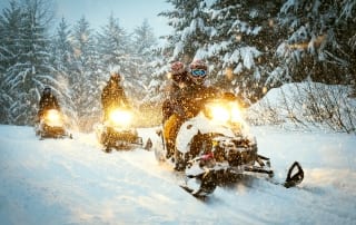 Snowmobiles through the forest | Access to snowmobile trails