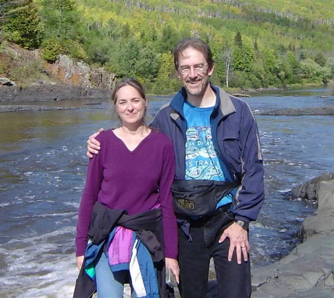 Eve and Gary Wallinga posing near a river.