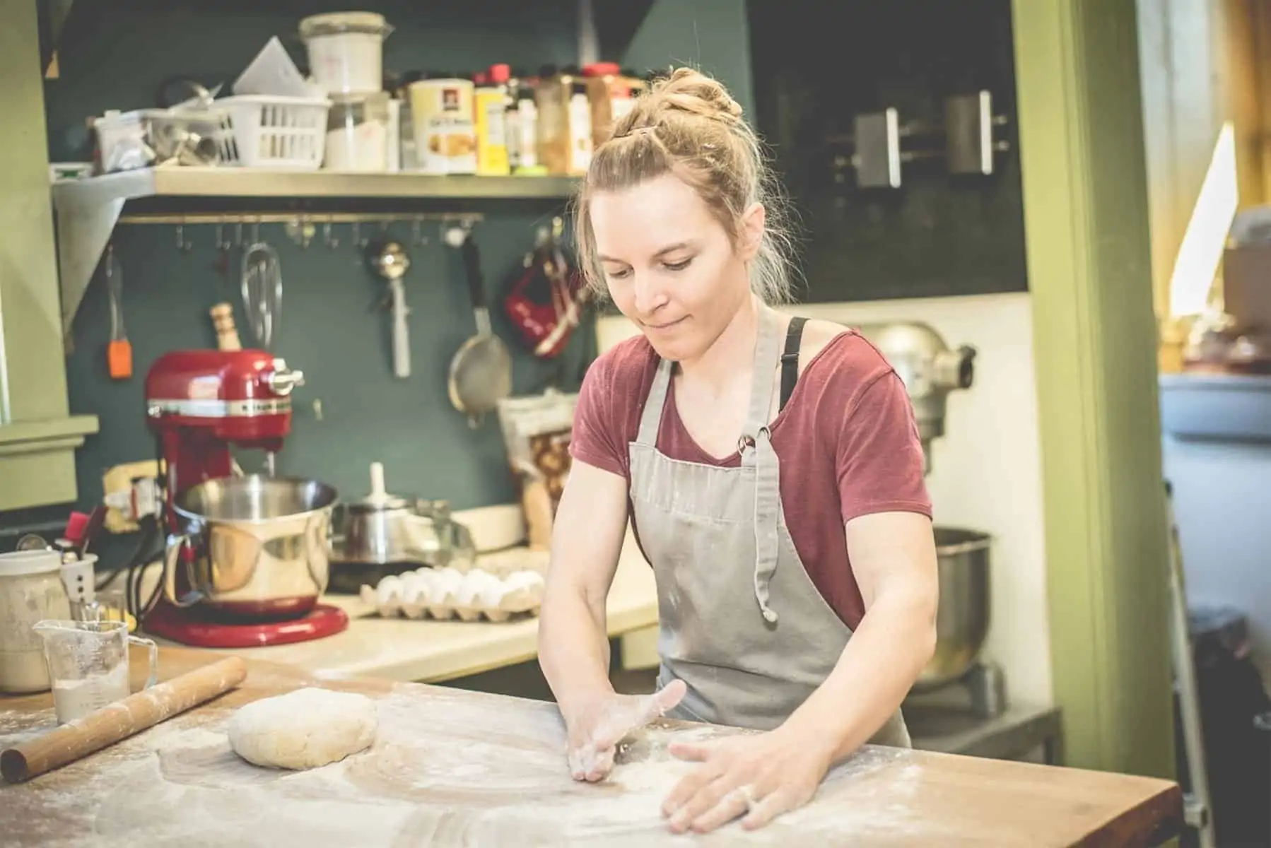 Woman molding dough.