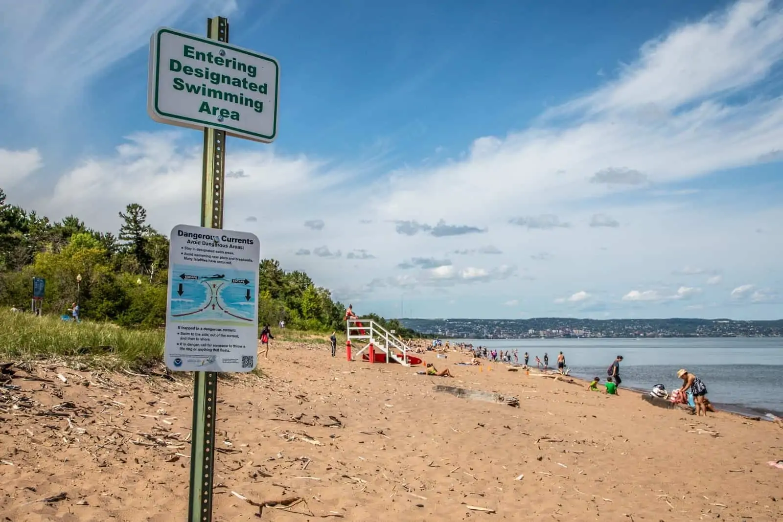 Beach signs. Text: Entering Designated Swimming Area.